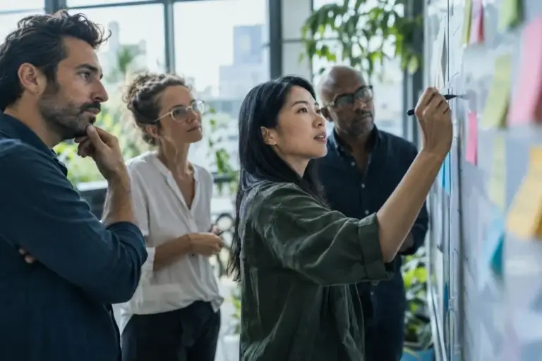 Small team planning together at a whiteboard